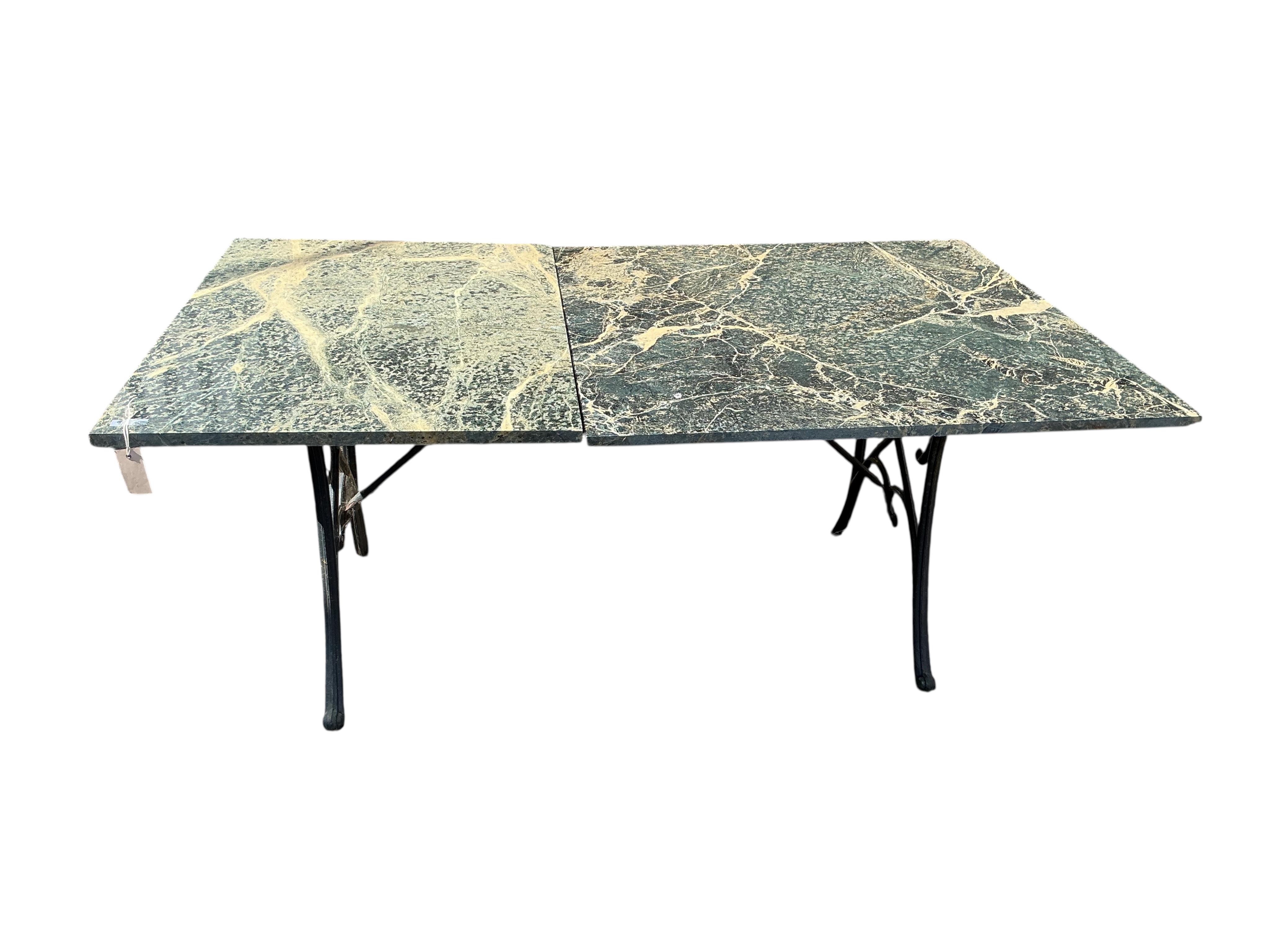 A rectangular reconstituted marble and cast metal garden table, marble in two sections, width 160cm, depth 94cm, height 66cm